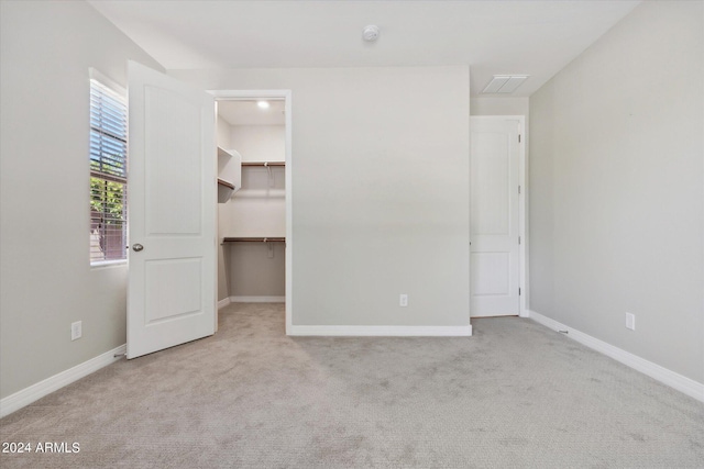 10630 W Pinchot Ave, Avondale, AZ 85392 - unfurnished bedroom with a closet, a spacious closet, and light carpet