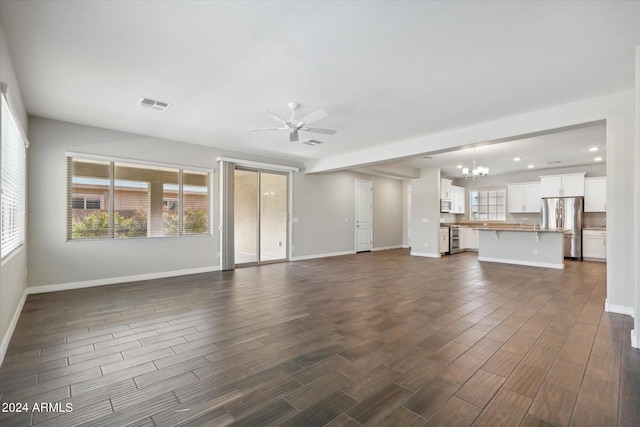 10630 W Pinchot Ave, Avondale, AZ 85392 - unfurnished living room with dark hardwood / wood-style floors and ceiling fan with notable chandelier