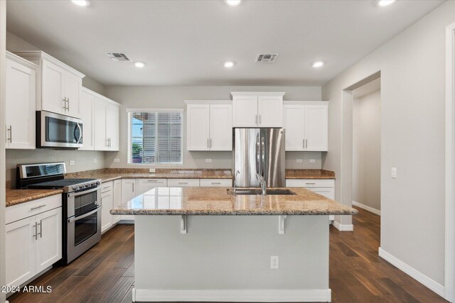 10630 W Pinchot Ave, Avondale, AZ 85392 - kitchen featuring appliances with stainless steel finishes, a kitchen island with sink, and white cabinets