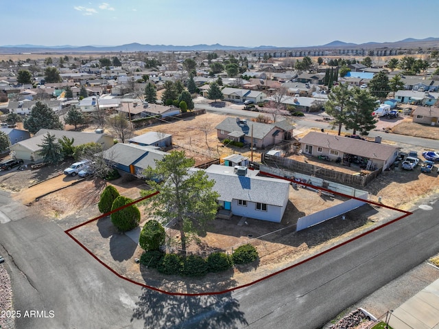 drone / aerial view featuring a residential view and a mountain view