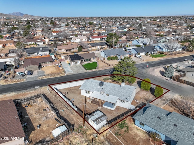 drone / aerial view featuring a residential view and a mountain view