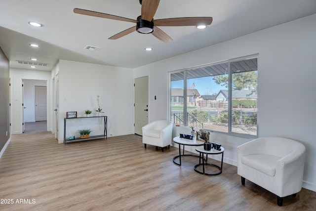 living area with light wood-type flooring, a ceiling fan, recessed lighting, and visible vents