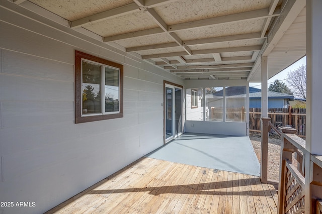 deck featuring a patio area and fence