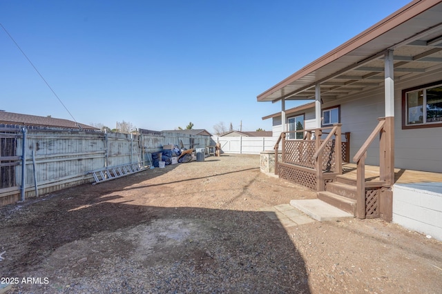 view of yard featuring a fenced backyard and a wooden deck