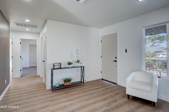 entryway with plenty of natural light, light wood finished floors, and visible vents