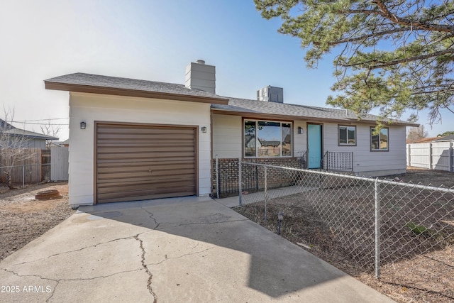 single story home with a chimney, concrete driveway, a fenced front yard, and an attached garage
