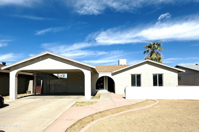 single story home featuring concrete driveway, roof with shingles, and stucco siding