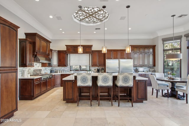 kitchen featuring visible vents, under cabinet range hood, appliances with stainless steel finishes, light countertops, and decorative backsplash