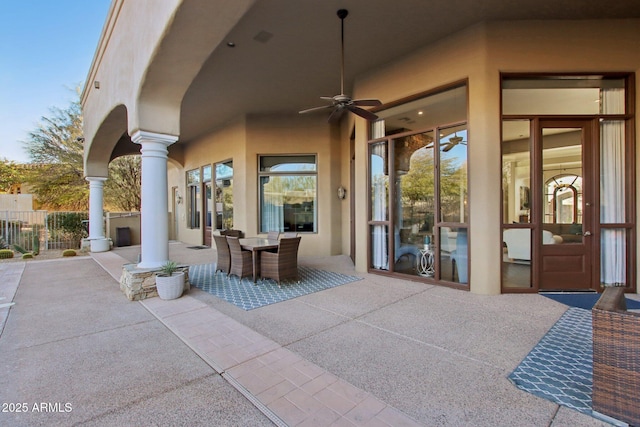 view of patio / terrace with ceiling fan, outdoor dining space, and fence