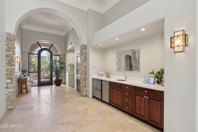 full bathroom with ornamental molding, decorative columns, recessed lighting, a high ceiling, and vanity