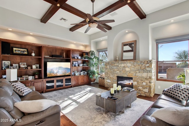 living area featuring visible vents, a healthy amount of sunlight, a ceiling fan, and wood finished floors