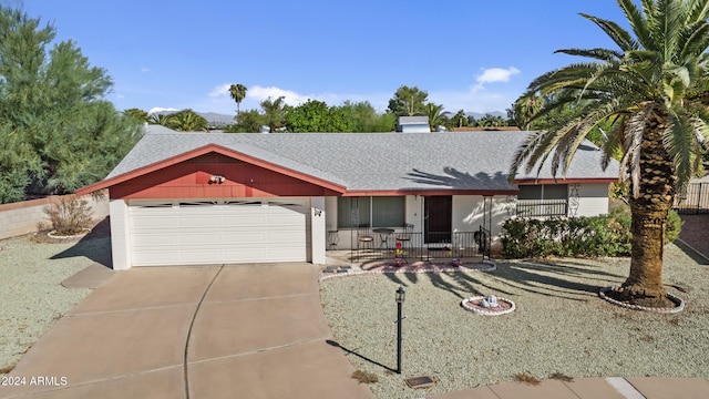 ranch-style house featuring a porch and a garage