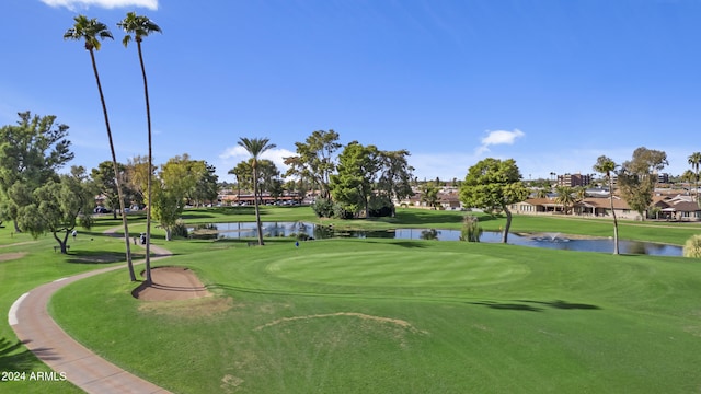 view of home's community featuring a water view and a lawn