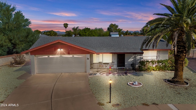 single story home with covered porch and a garage