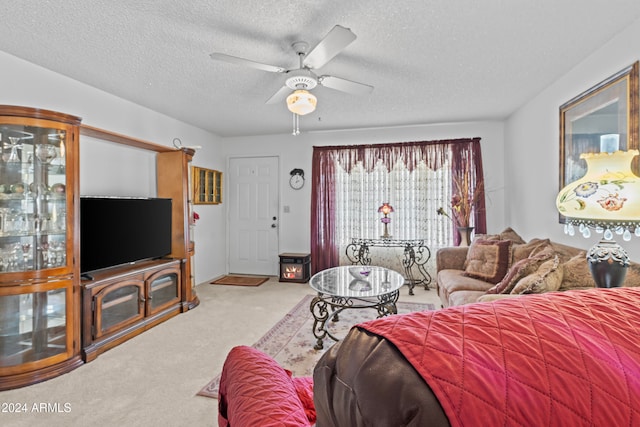 living room with a textured ceiling, carpet, and ceiling fan