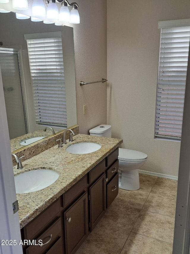 bathroom featuring walk in shower, tile patterned floors, vanity, and toilet