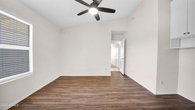 empty room featuring ceiling fan, wood finished floors, visible vents, and baseboards