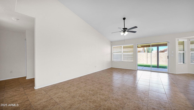 tiled spare room with a ceiling fan, vaulted ceiling, and baseboards