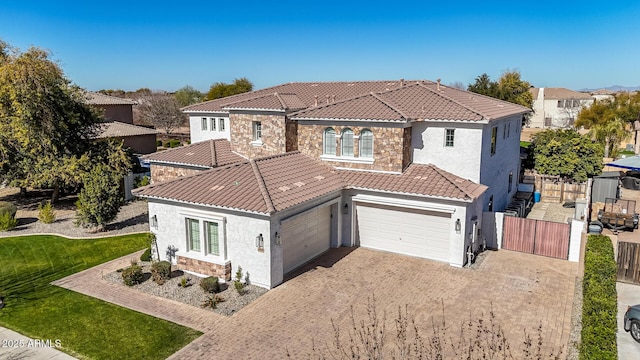 mediterranean / spanish home with a garage