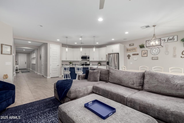 living room with light tile patterned floors and ceiling fan