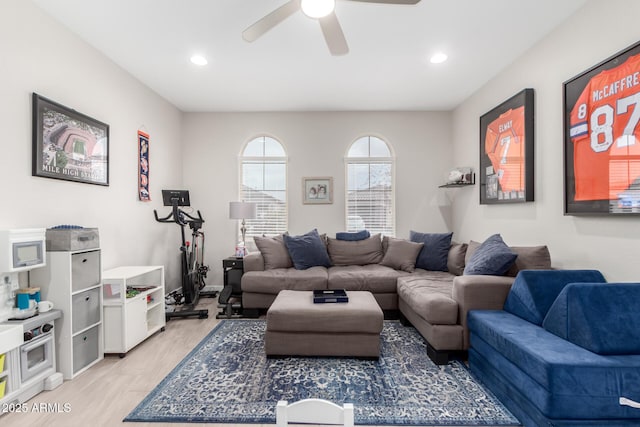 living room with ceiling fan and light hardwood / wood-style flooring