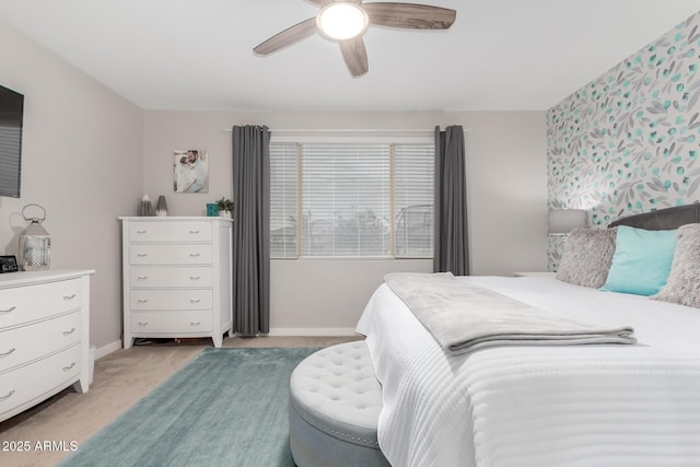 bedroom featuring light colored carpet and ceiling fan