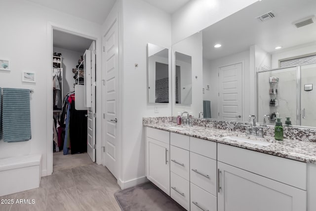 bathroom with vanity and an enclosed shower