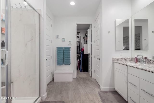 bathroom featuring vanity and an enclosed shower