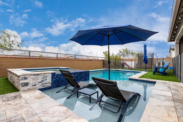 view of swimming pool featuring an in ground hot tub and a patio area