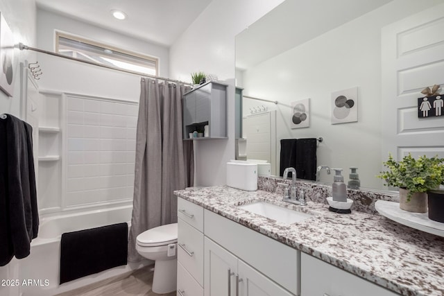 full bathroom with vanity, shower / bath combo with shower curtain, and toilet