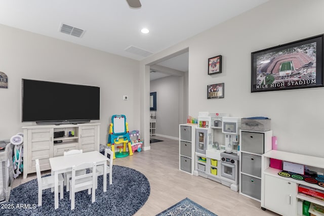 playroom featuring light wood-type flooring