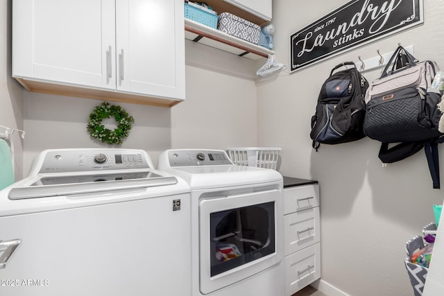 laundry room featuring cabinets and washer and clothes dryer