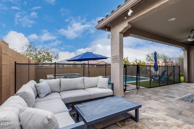 view of patio with ceiling fan, a pool, and an outdoor living space