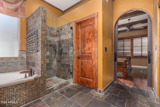 bathroom with ceiling fan, beamed ceiling, plus walk in shower, and ornamental molding