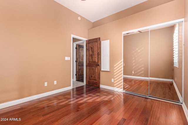 unfurnished bedroom featuring hardwood / wood-style flooring and a closet