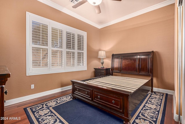 bedroom with dark hardwood / wood-style flooring, ceiling fan, and ornamental molding