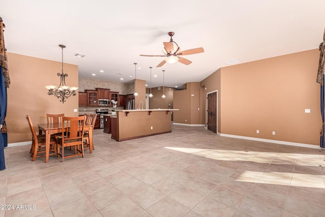 tiled dining room featuring ceiling fan with notable chandelier