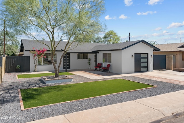 8732 E Arlington Rd, Scottsdale, AZ 85250 - view of front of property featuring a garage, stucco siding, roof with shingles, and driveway