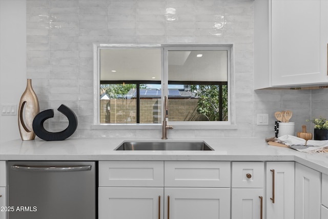 8732 E Arlington Rd, Scottsdale, AZ 85250 - kitchen with dishwasher, a sink, white cabinetry, and decorative backsplash