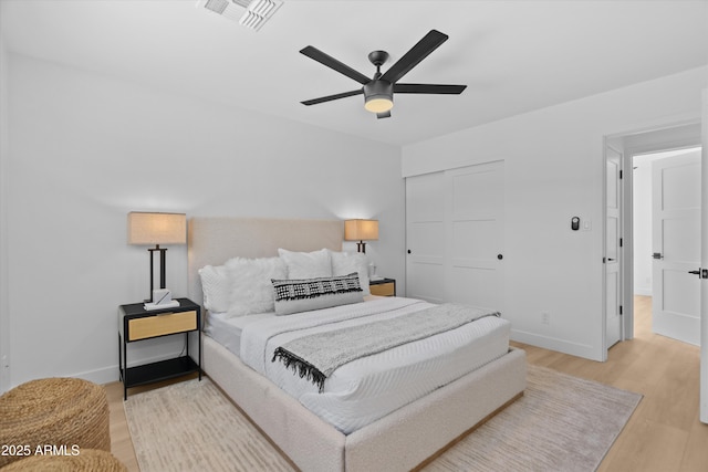8732 E Arlington Rd, Scottsdale, AZ 85250 - bedroom featuring a closet, light wood-type flooring, baseboards, and a ceiling fan