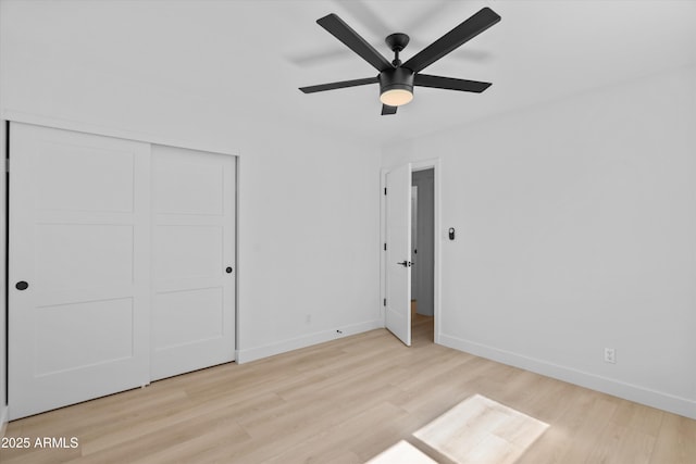 8732 E Arlington Rd, Scottsdale, AZ 85250 - unfurnished bedroom with wood finished floors, baseboards, a closet, and ceiling fan