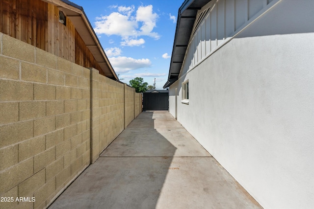 8732 E Arlington Rd, Scottsdale, AZ 85250 - view of home's exterior with board and batten siding, a patio area, and stucco siding