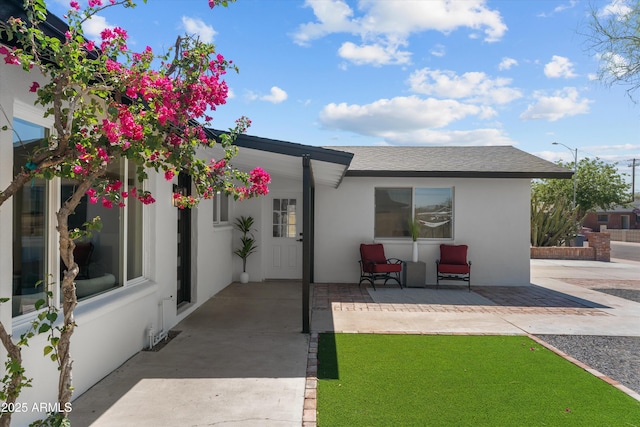 8732 E Arlington Rd, Scottsdale, AZ 85250 - rear view of house with stucco siding, a patio area, and roof with shingles