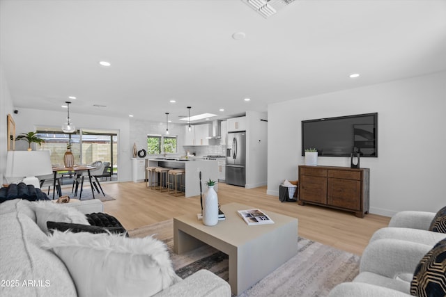8732 E Arlington Rd, Scottsdale, AZ 85250 - living room featuring light wood finished floors, recessed lighting, and baseboards