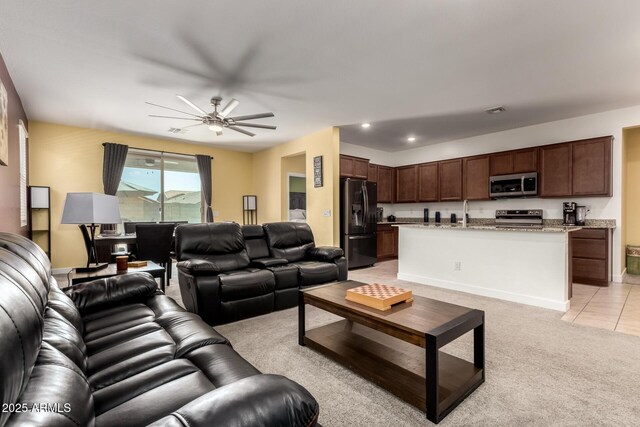 23407 W Winslow Ave, Buckeye, AZ 85326 - living area featuring a ceiling fan, light colored carpet, light tile patterned floors, and baseboards