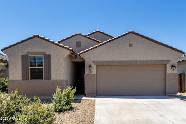 23407 W Winslow Ave, Buckeye, AZ 85326 - mediterranean / spanish house with stucco siding, concrete driveway, a garage, and a tiled roof