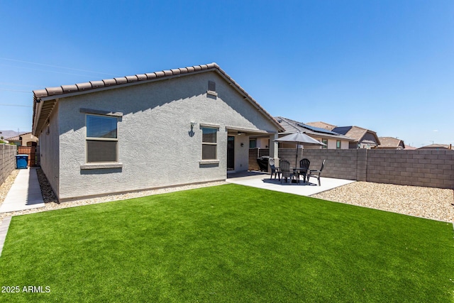23407 W Winslow Ave, Buckeye, AZ 85326 - back of house with stucco siding and a patio