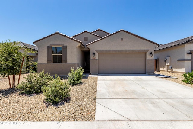 23407 W Winslow Ave, Buckeye, AZ 85326 - mediterranean / spanish house featuring stucco siding, a garage, concrete driveway, and a tile roof
