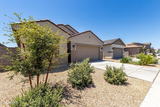 23407 W Winslow Ave, Buckeye, AZ 85326 - view of front of property featuring driveway, an attached garage, stucco siding, fence, and a tiled roof