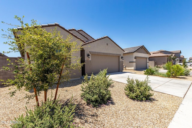 23407 W Winslow Ave, Buckeye, AZ 85326 - view of front of home featuring stucco siding, driveway, an attached garage, a tile roof, and fence